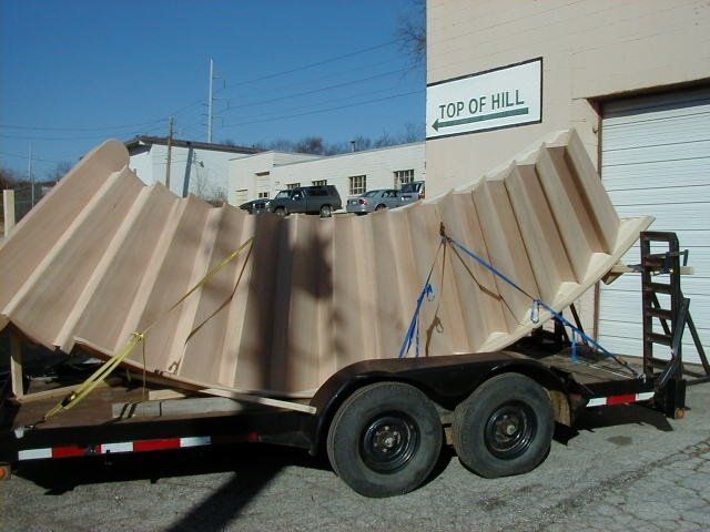 A trailer is parked in front of a building that says top of hill