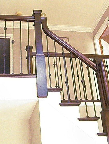 A staircase with a wooden railing and white steps