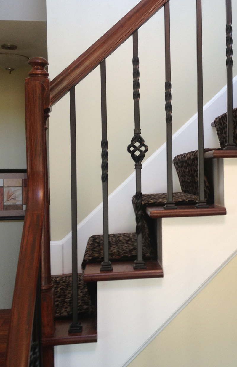 A staircase with a wooden railing and a metal railing