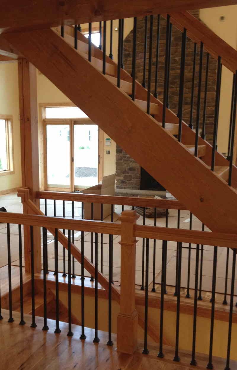 A wooden staircase with a metal railing in a house