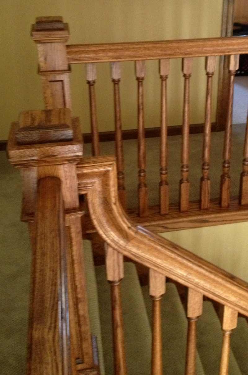 A close up of a wooden railing on a staircase