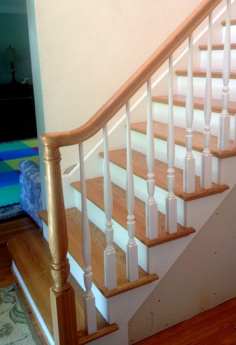 A staircase with wooden steps and white railings