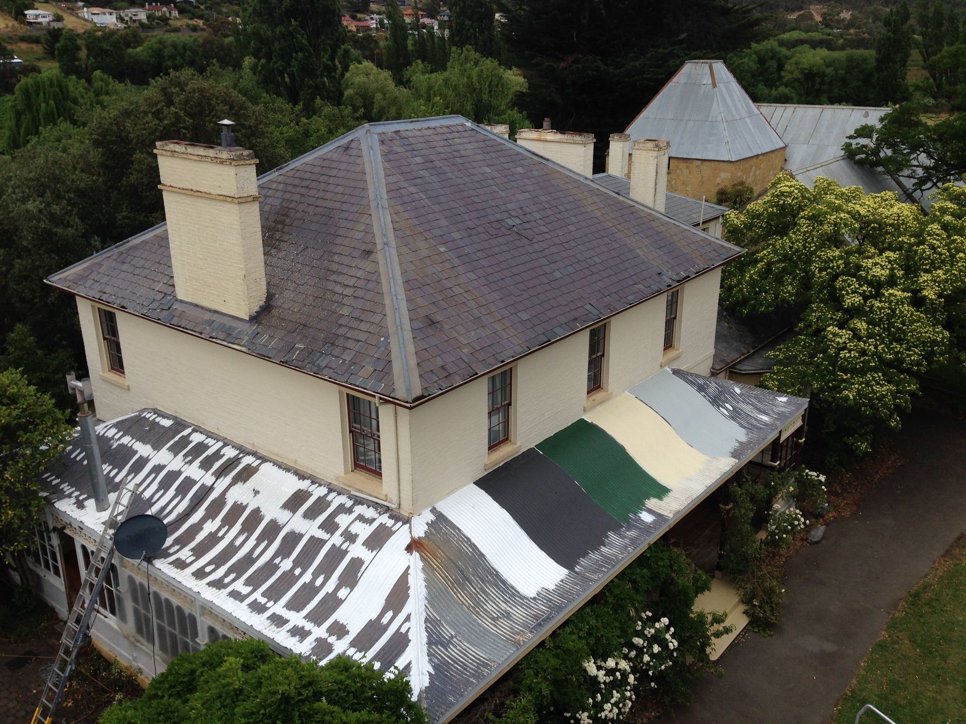 Ogee style colnial verandah roof Roof restoration repairs small cottage painting heritage and slate roofing hobart australia