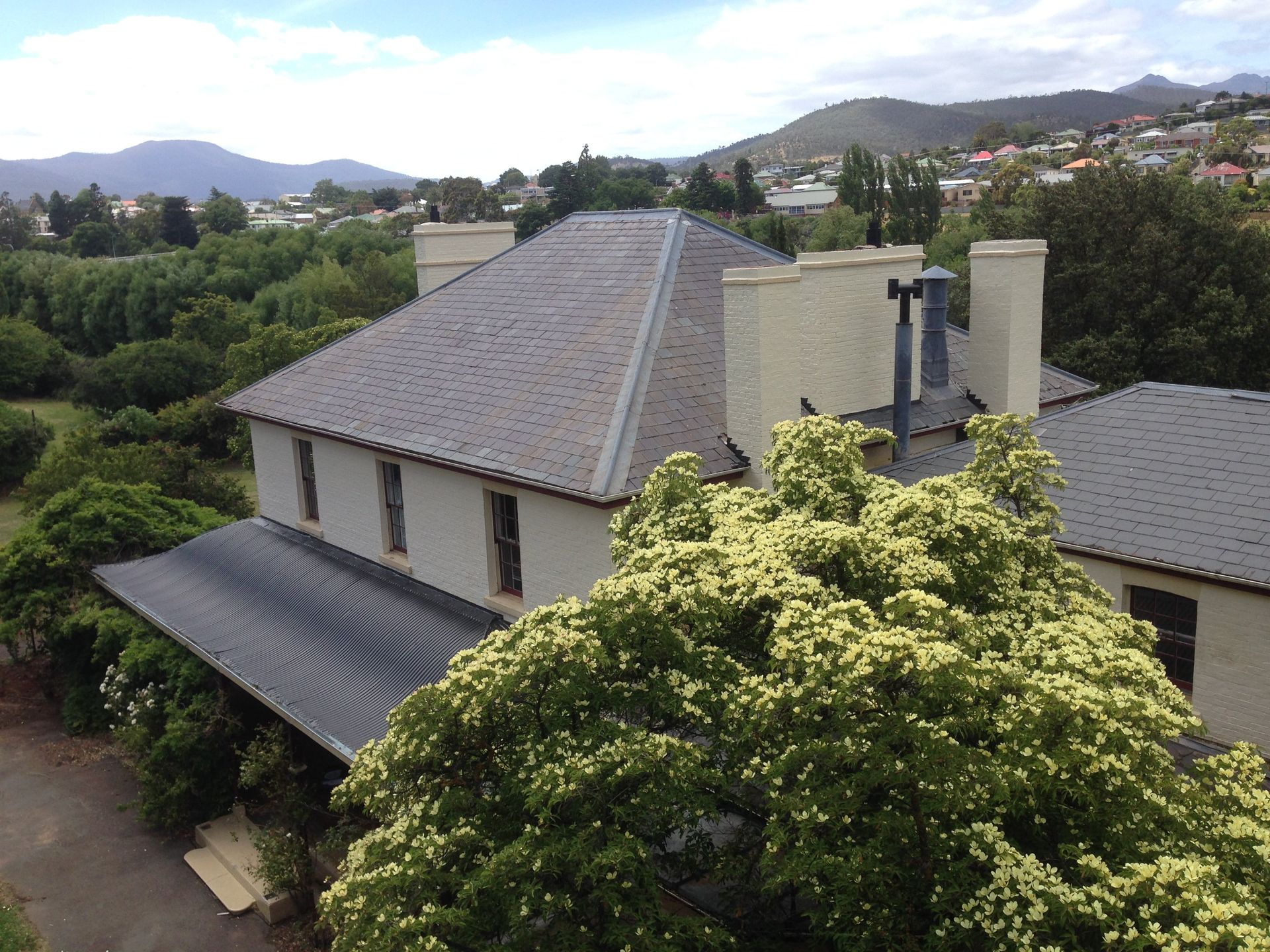 Ogee style colnial verandah roof Roof restoration repairs small cottage painting heritage and slate roofing hobart australia