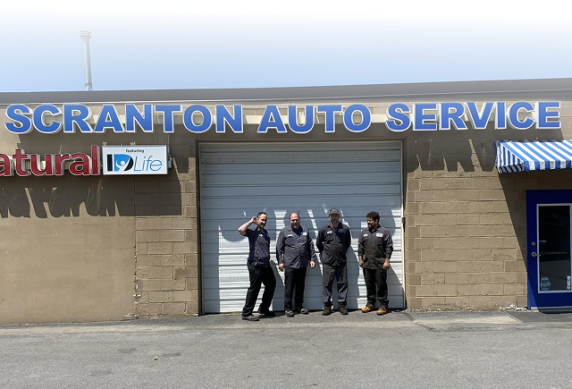 Five people posing outside Scranton Auto Service garage | Scranton Auto Service