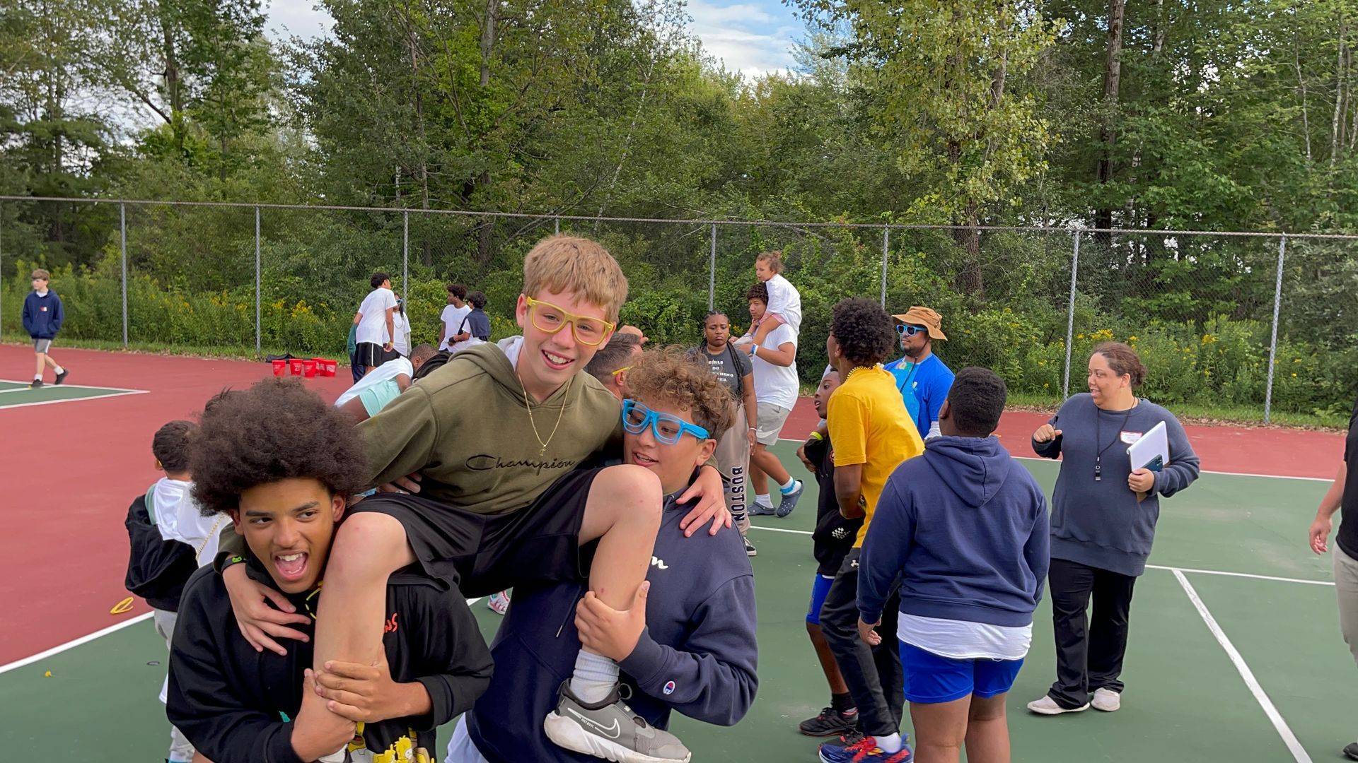 two campers lifting a third camper in celebration