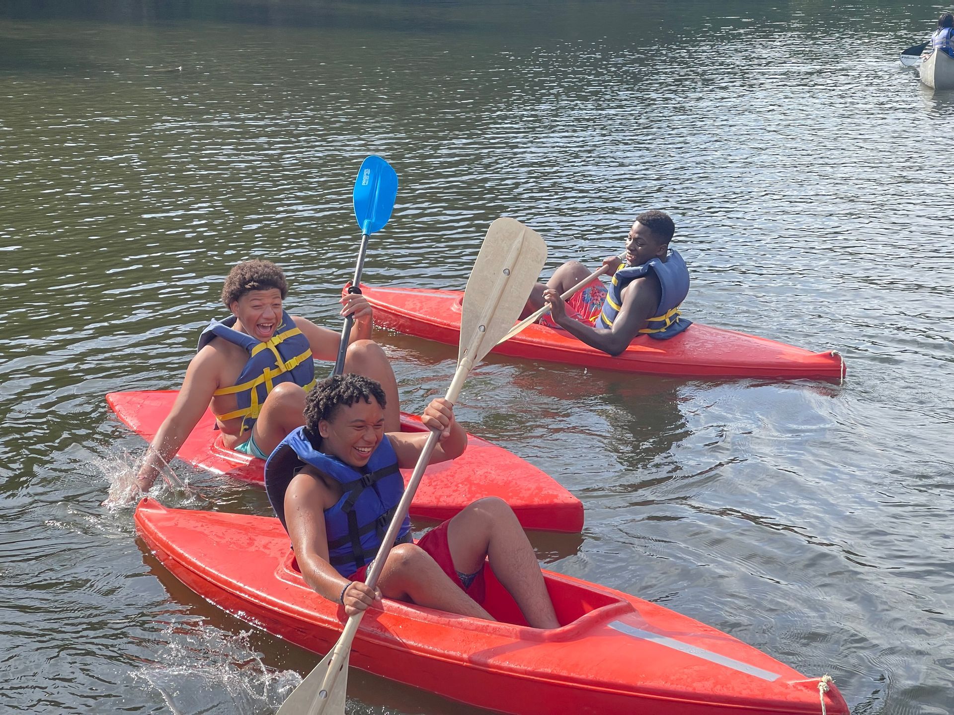 group of teen CITs racing in kayaks