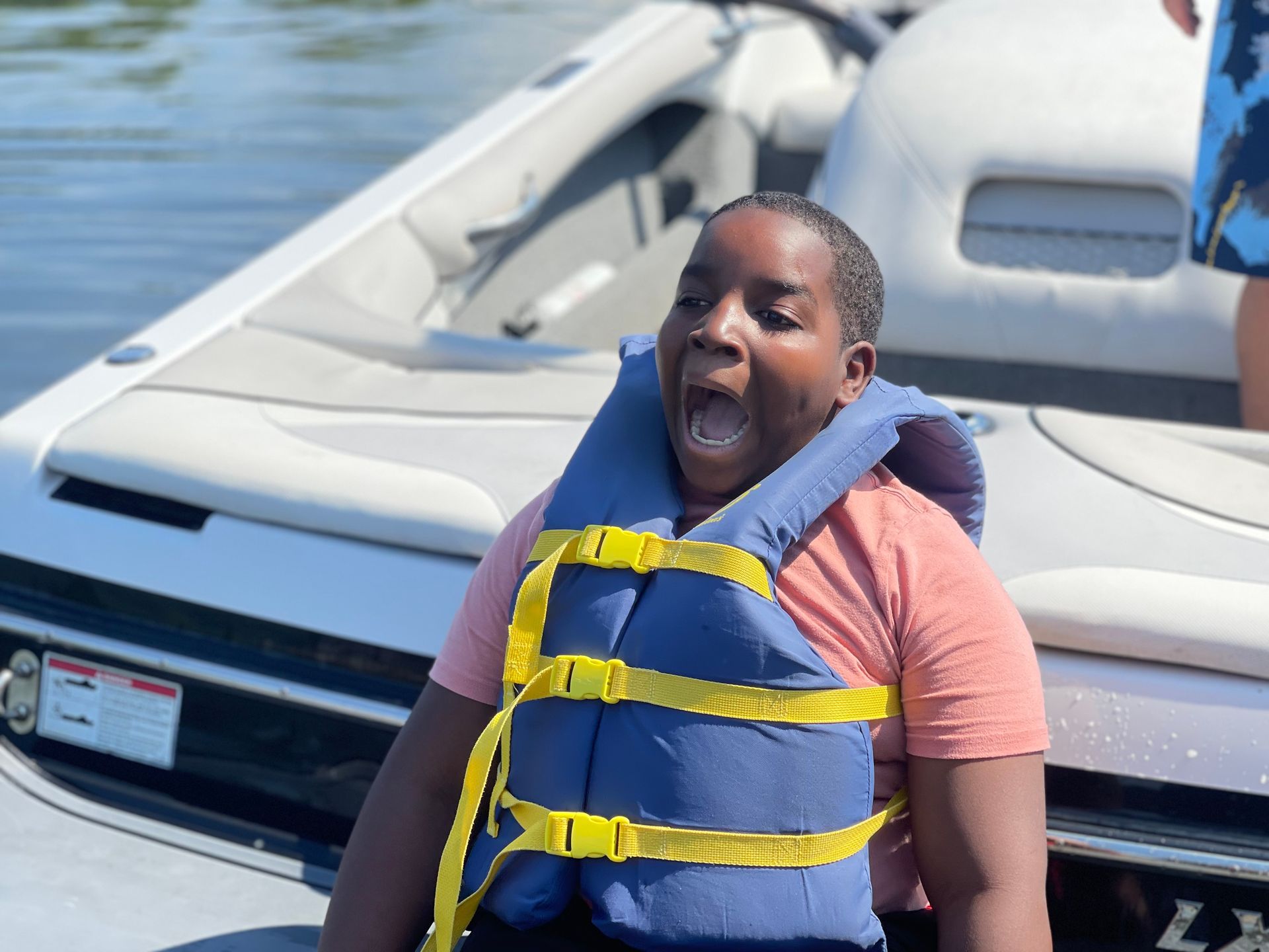 young camper behind a boat looking very excited