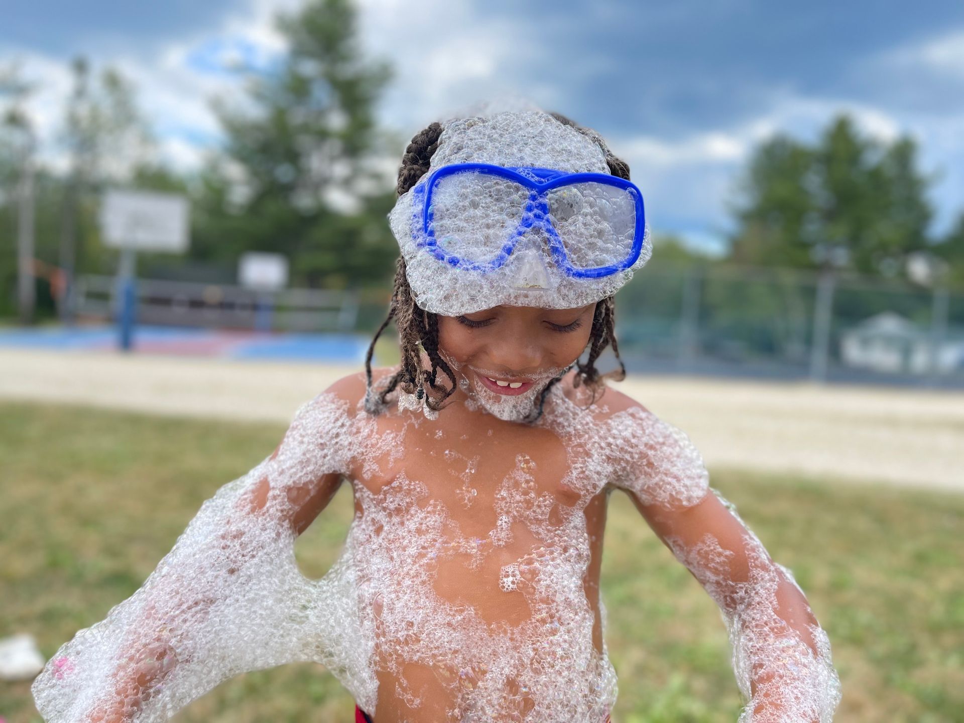 young boy covered in bubbles