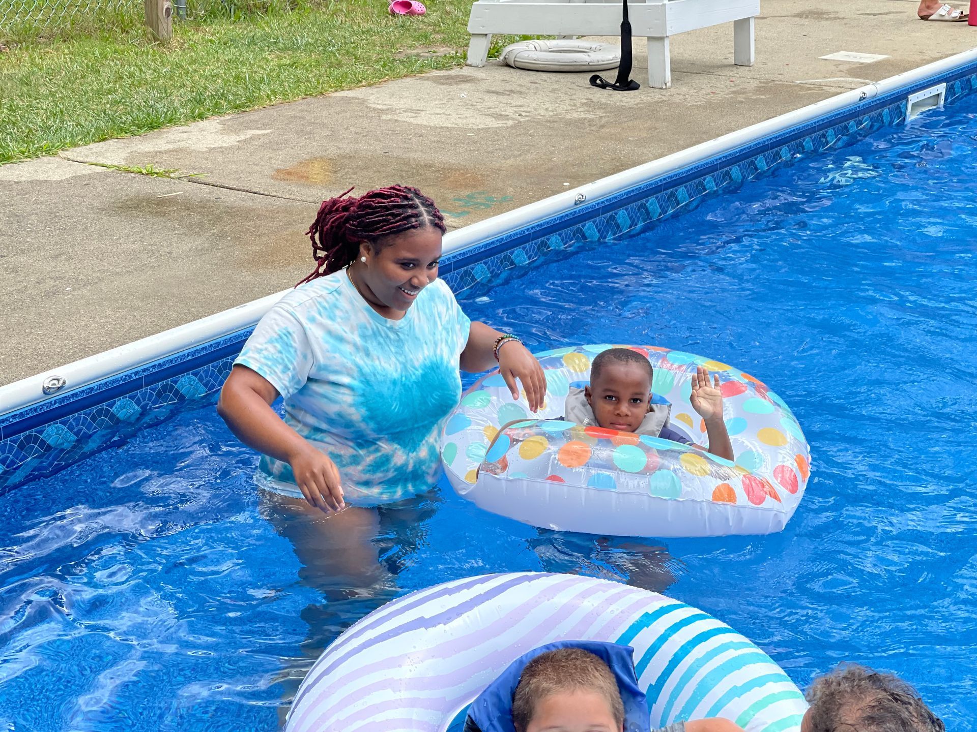 counselor helping a camper in the pool