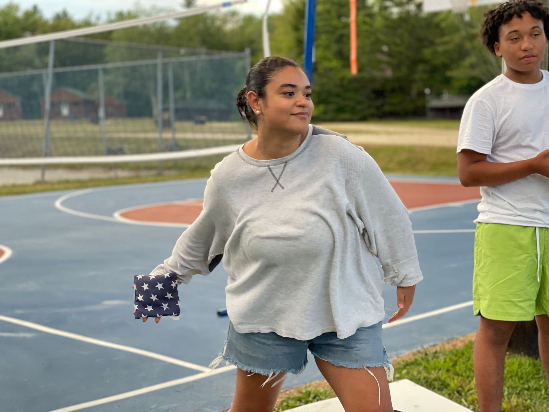 teen campers playing with bean bags