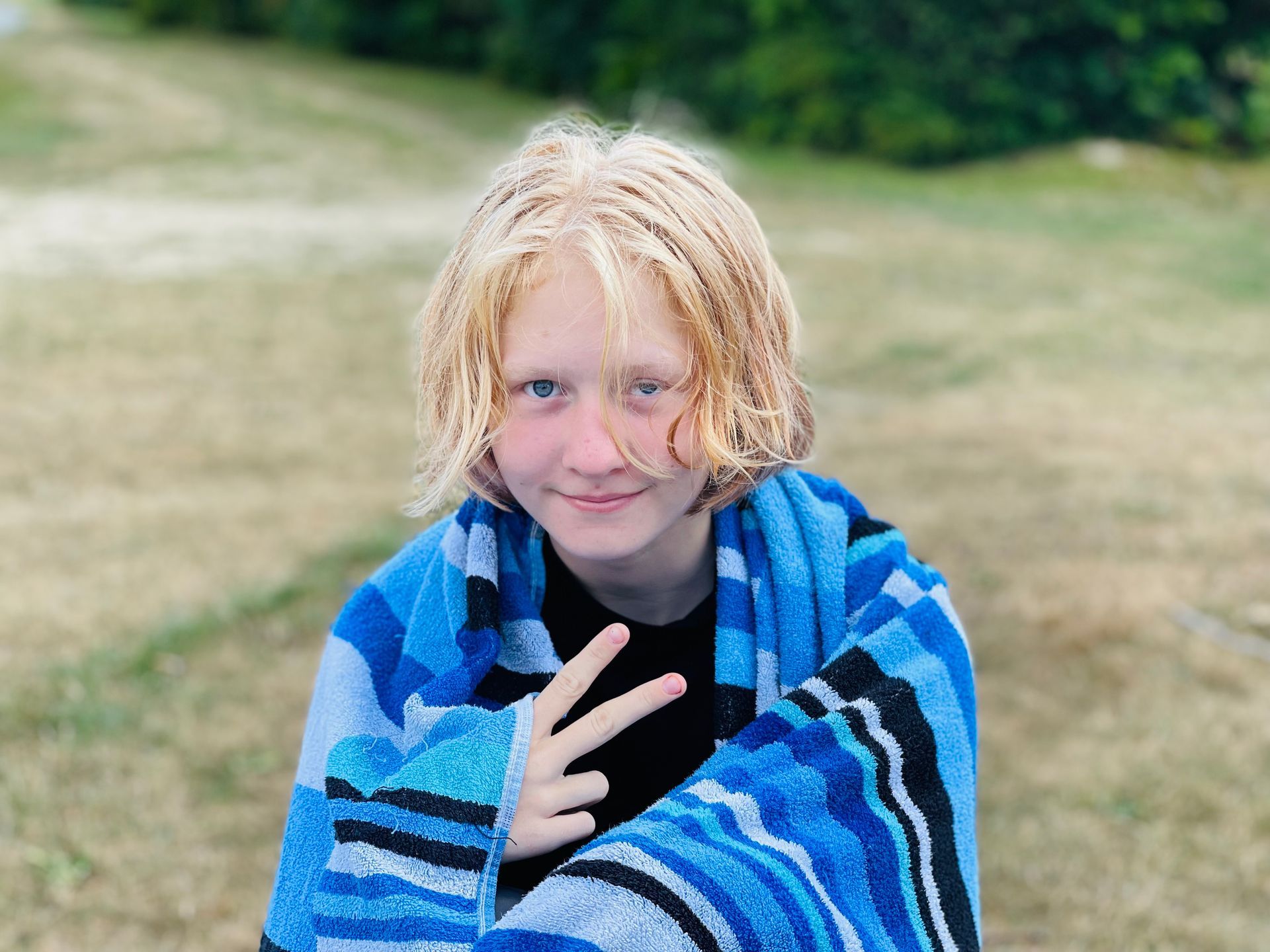 Blonde female camper giving the peace sign