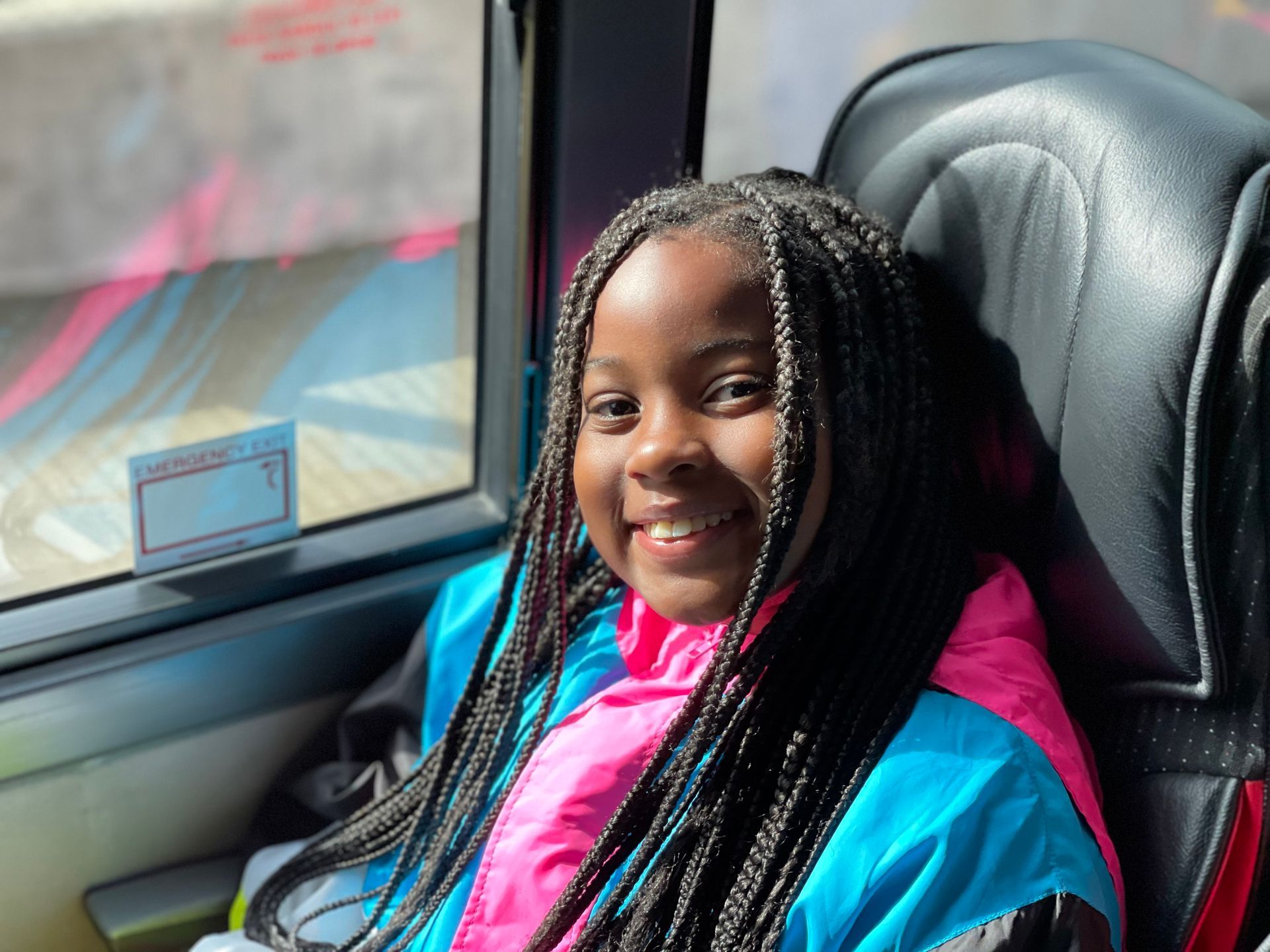 young female camper sitting on the bus