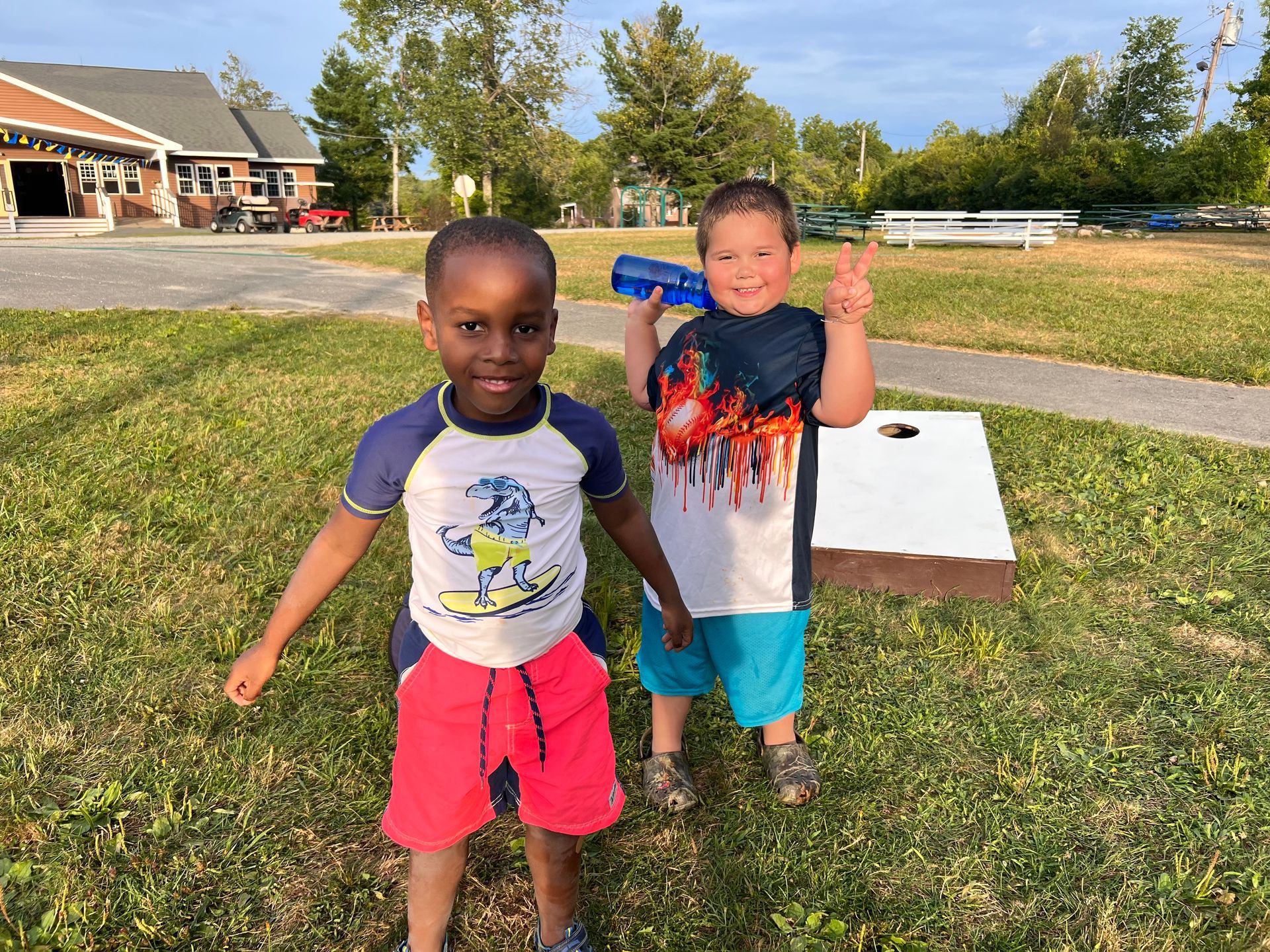 two 5 year old campers smiling in front of the cafeteria