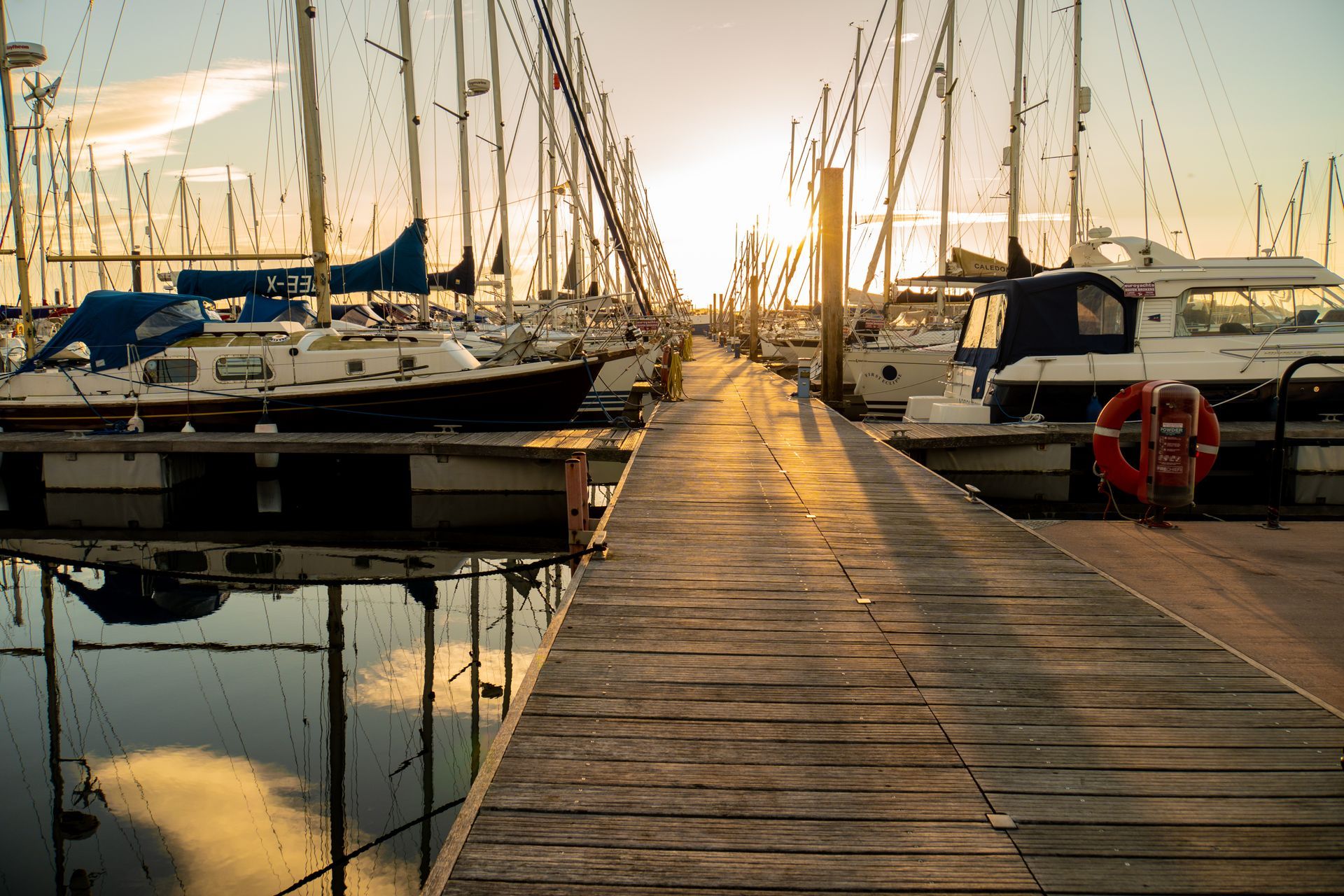 Boat mechanic at a dockside in the sunrise