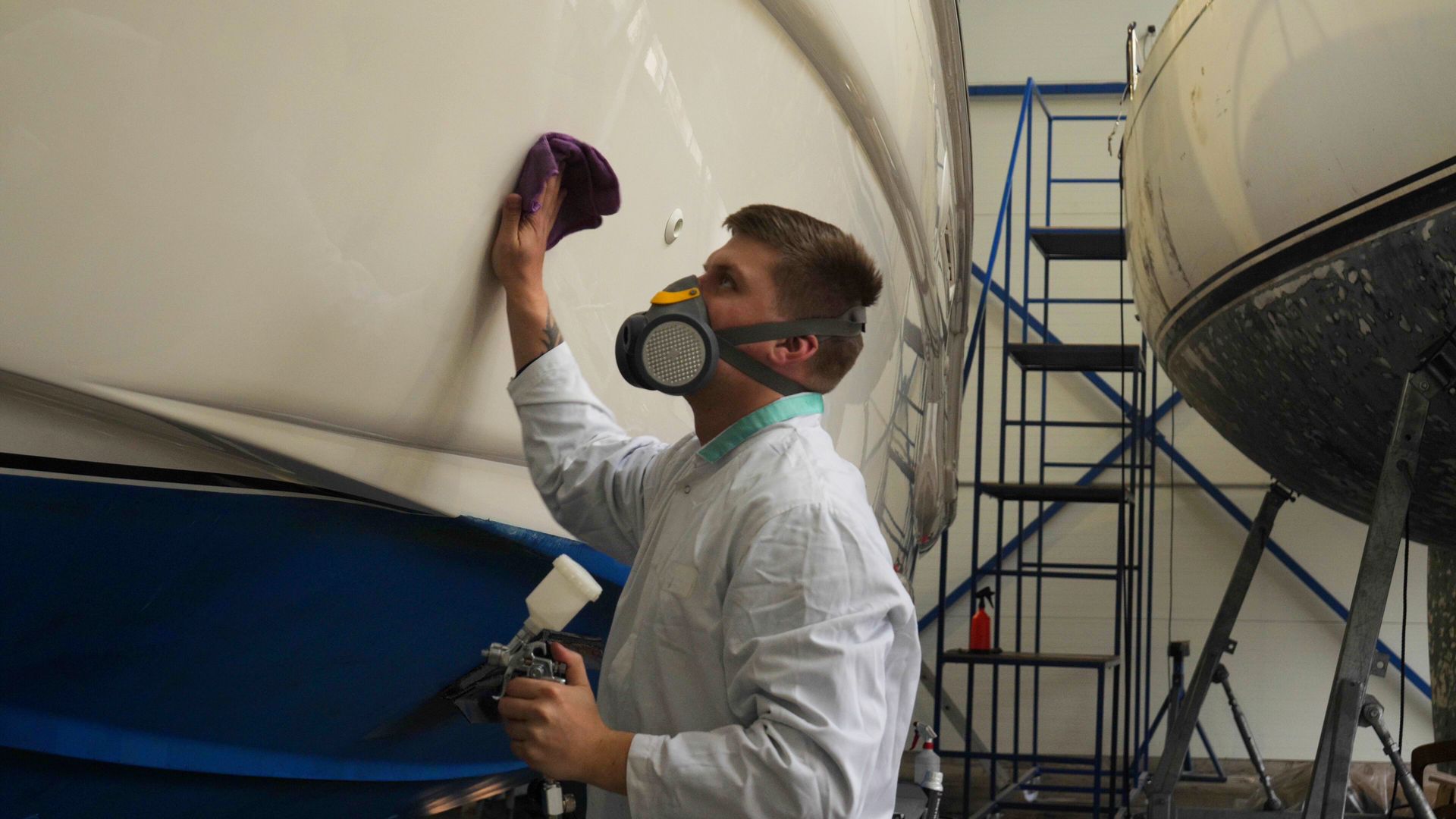 Boat mechanic cleaning the hull