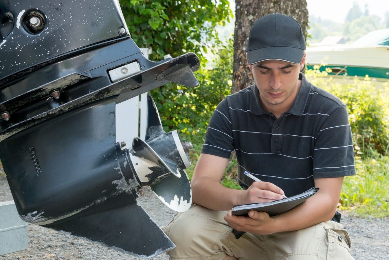 Boat motor repair in Long beach - mechanic checking the engine