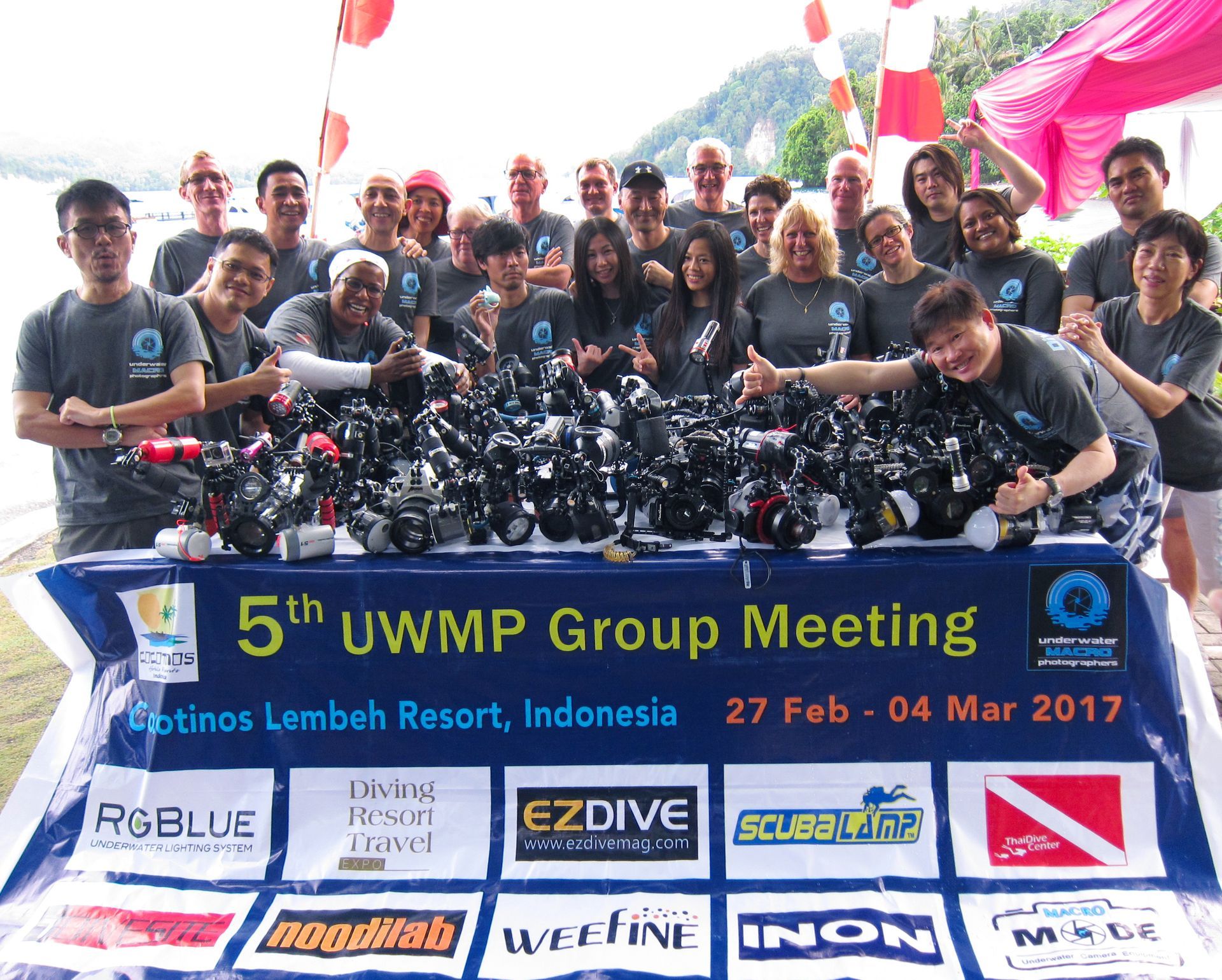 A group of people standing in front of a sign that says 5th uwmp group meeting