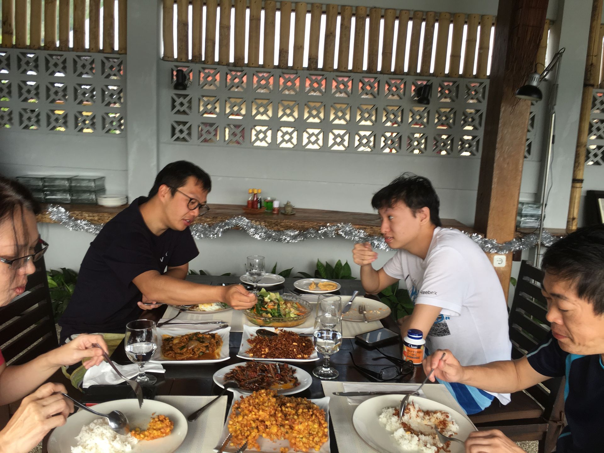 A group of people are sitting at a table eating food.