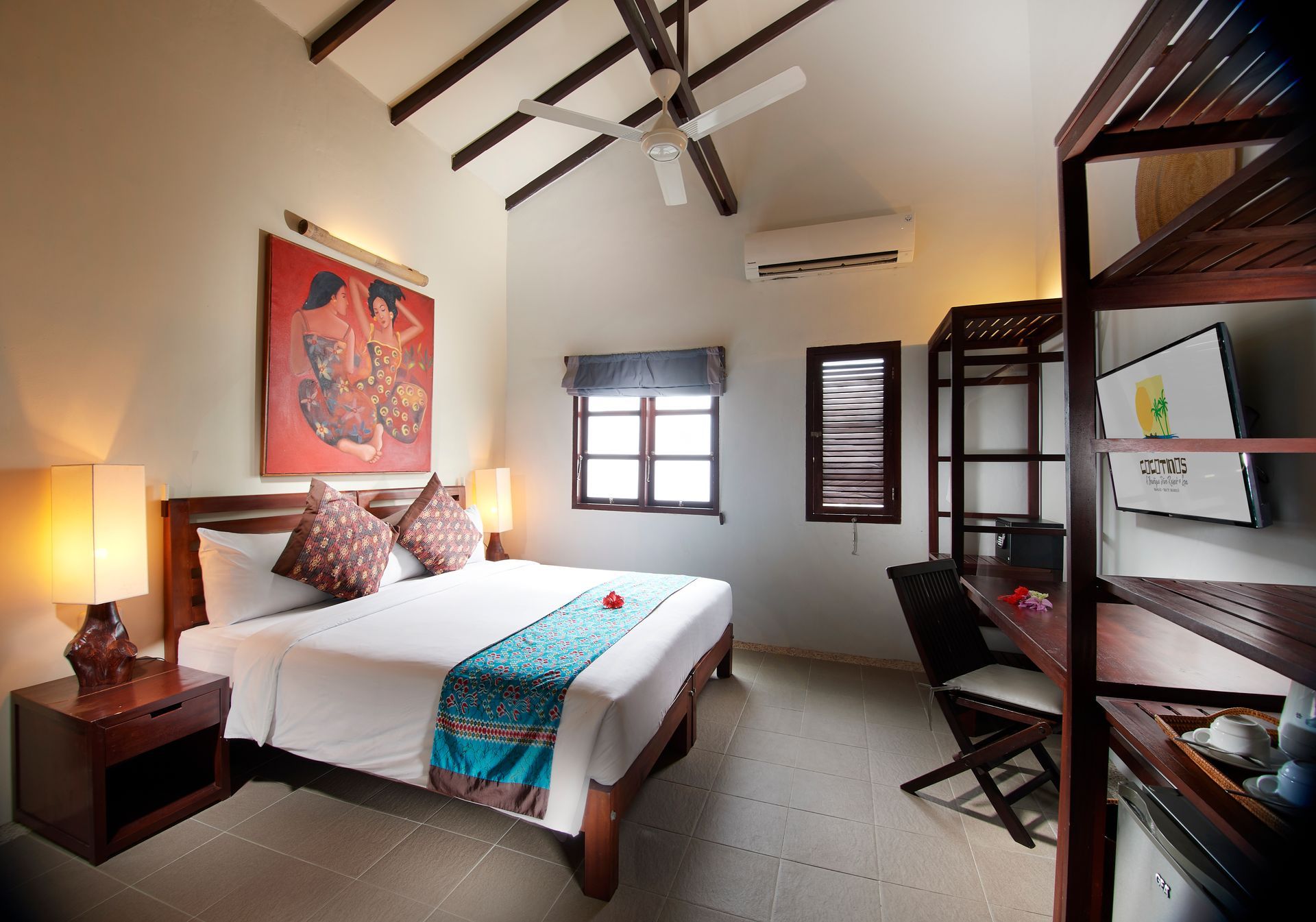 A hotel room with a king size bed and a television