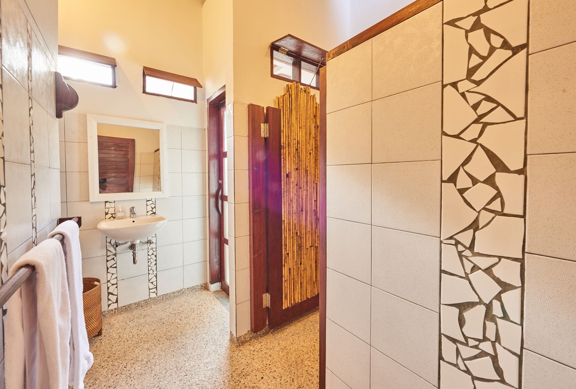 A bathroom with a sink and a walk in shower