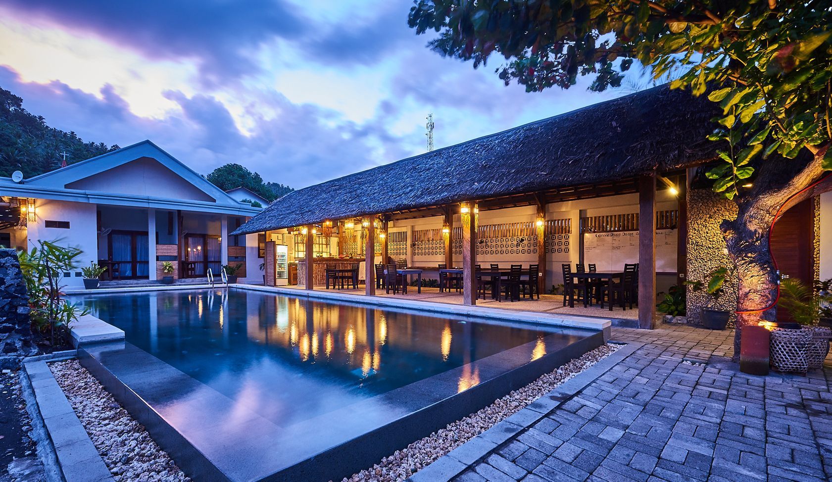 A large house with a swimming pool in front of it