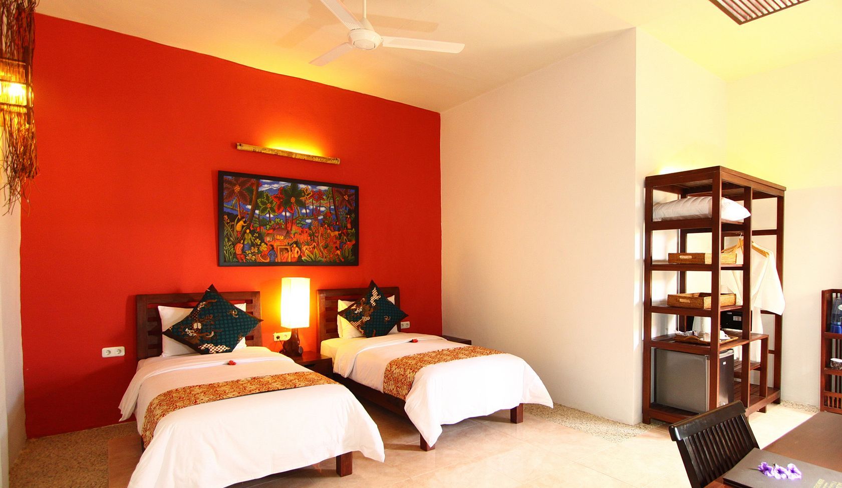 A hotel room with two beds and a ceiling fan