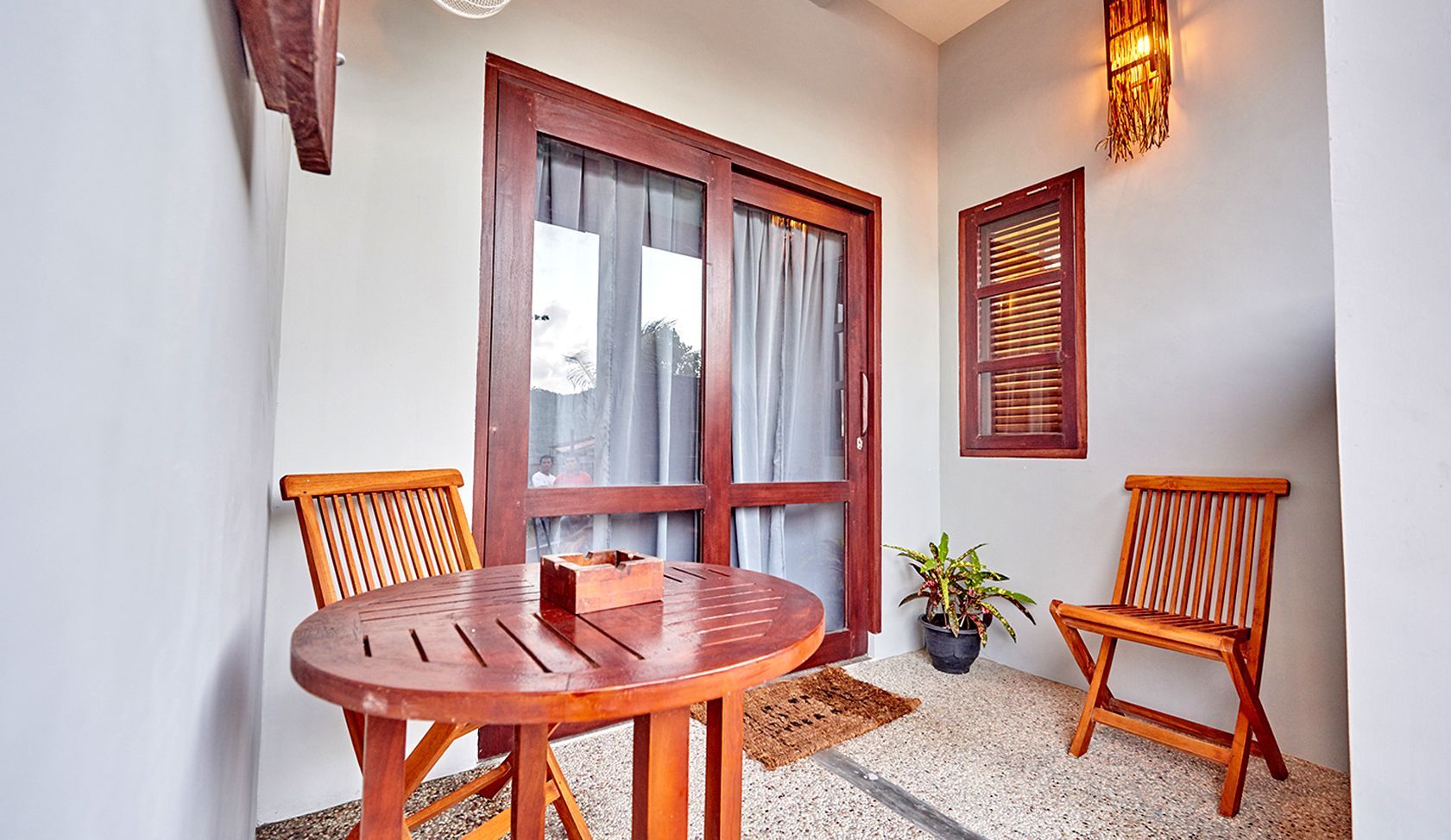 There is a table and chairs on the balcony.