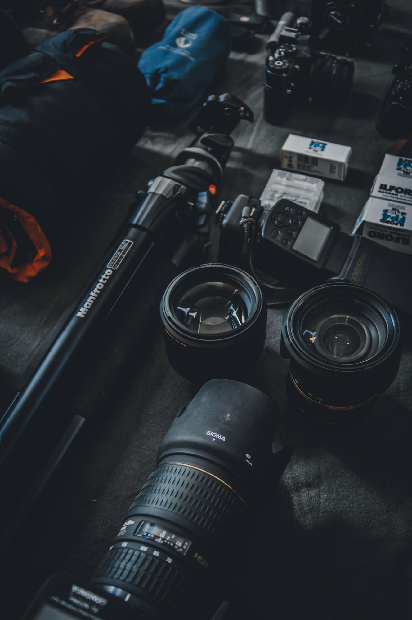 A bunch of camera lenses are sitting on a table.