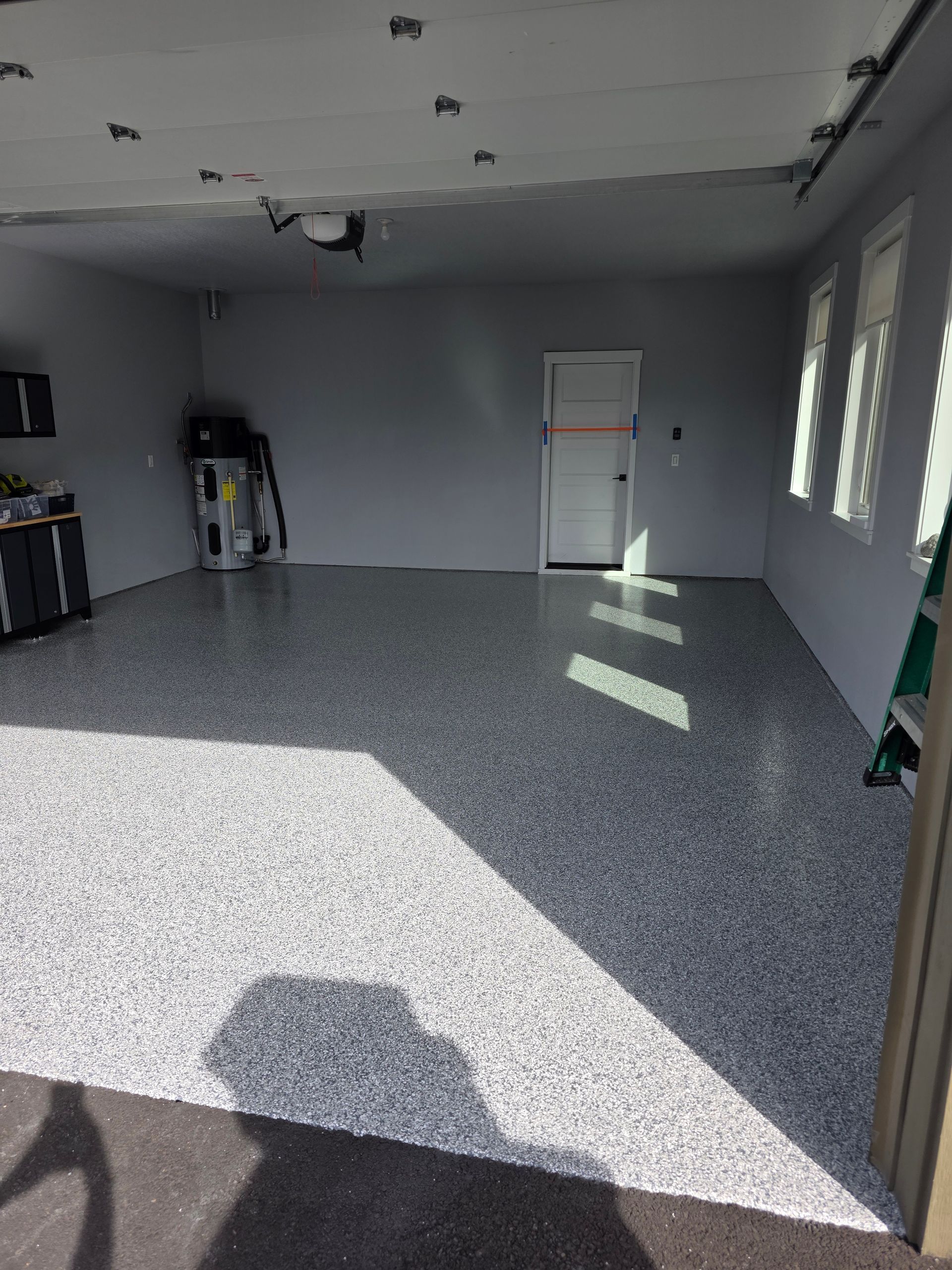 Mechanic assembling engine components in a workshop; black gloves, red overall.