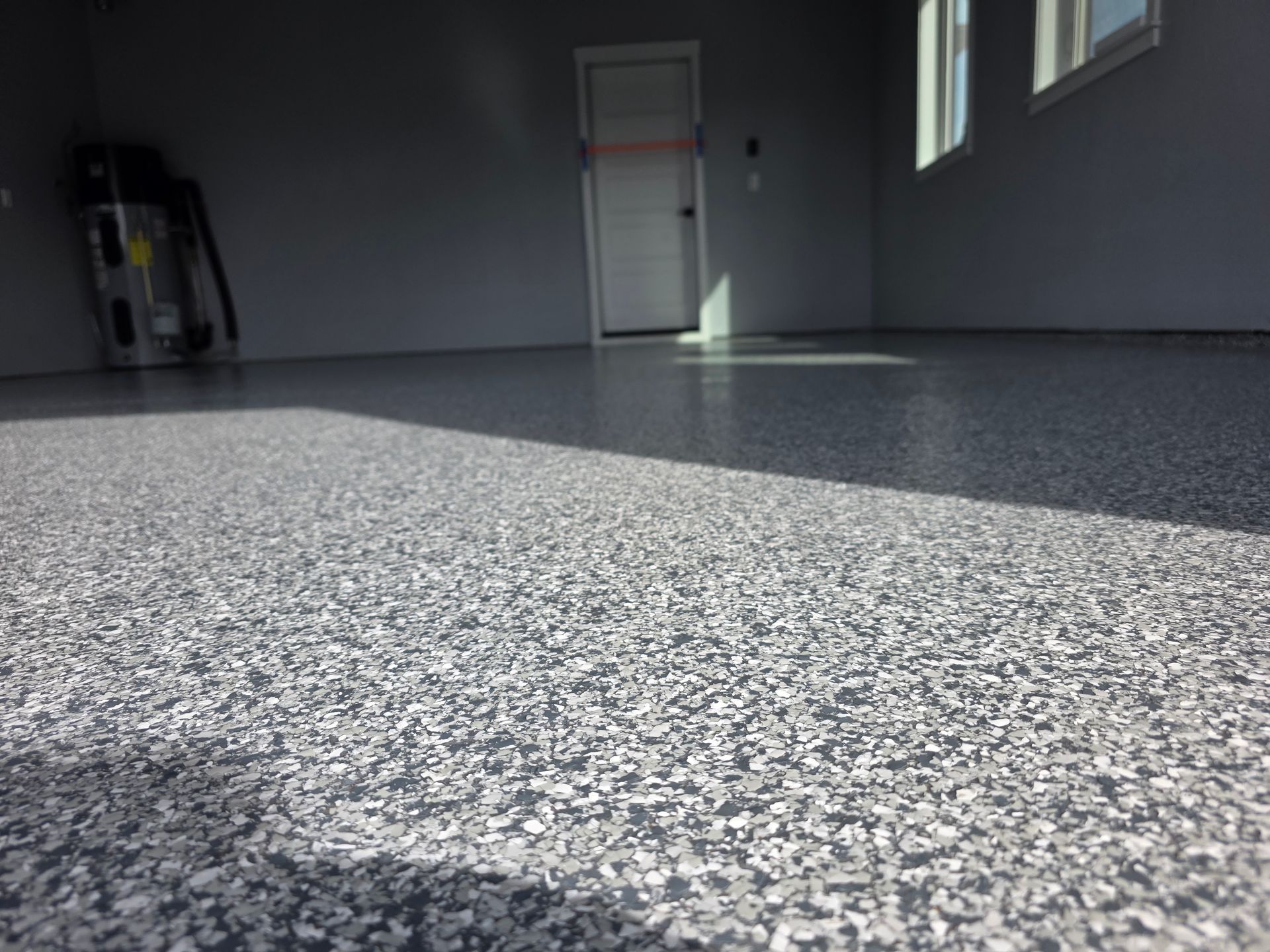 White car wheel well with air suspension installed; brake rotor, caliper, and suspension components visible.