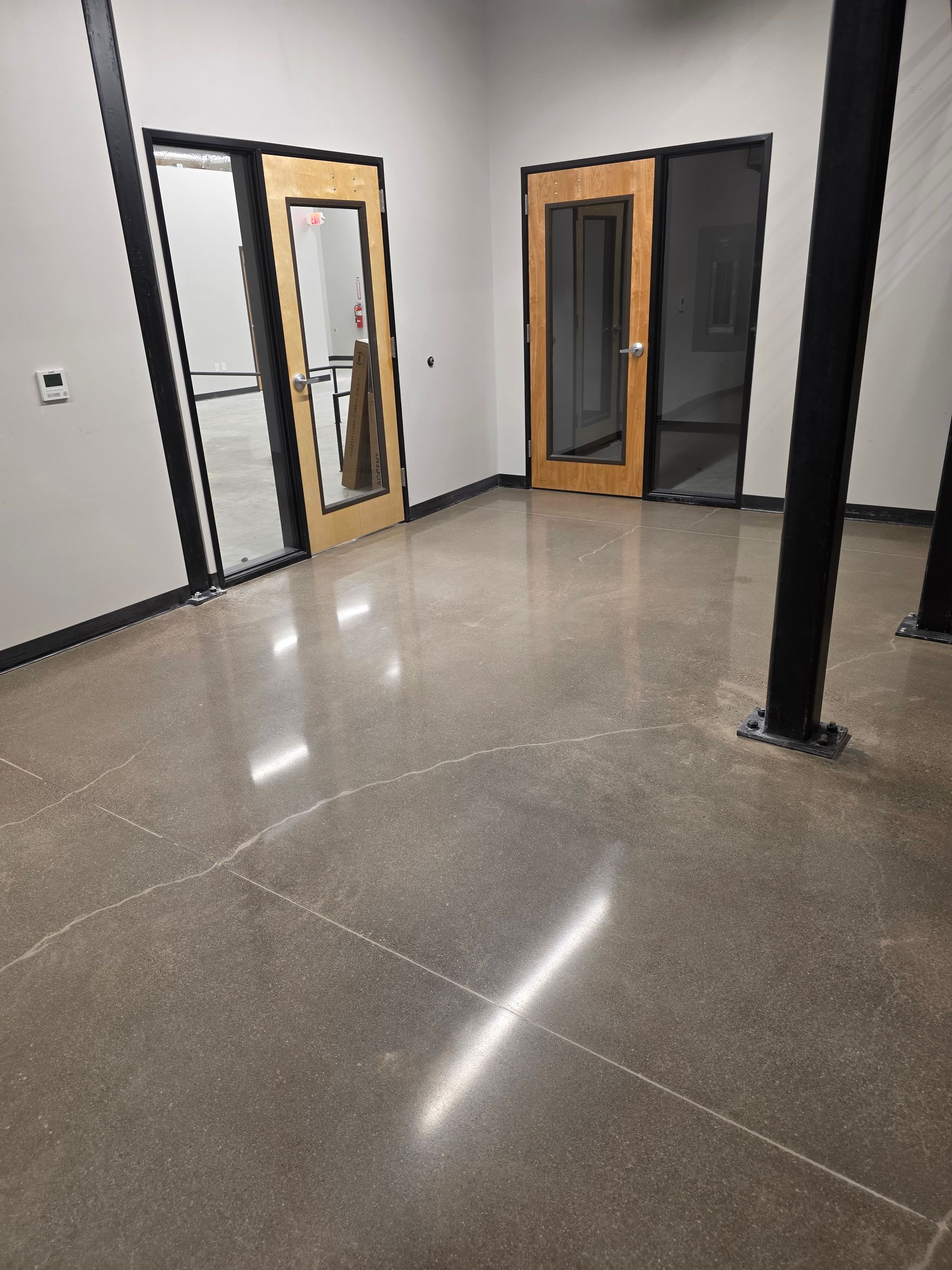 Mechanic lifts truck hood, revealing engine in a repair shop.