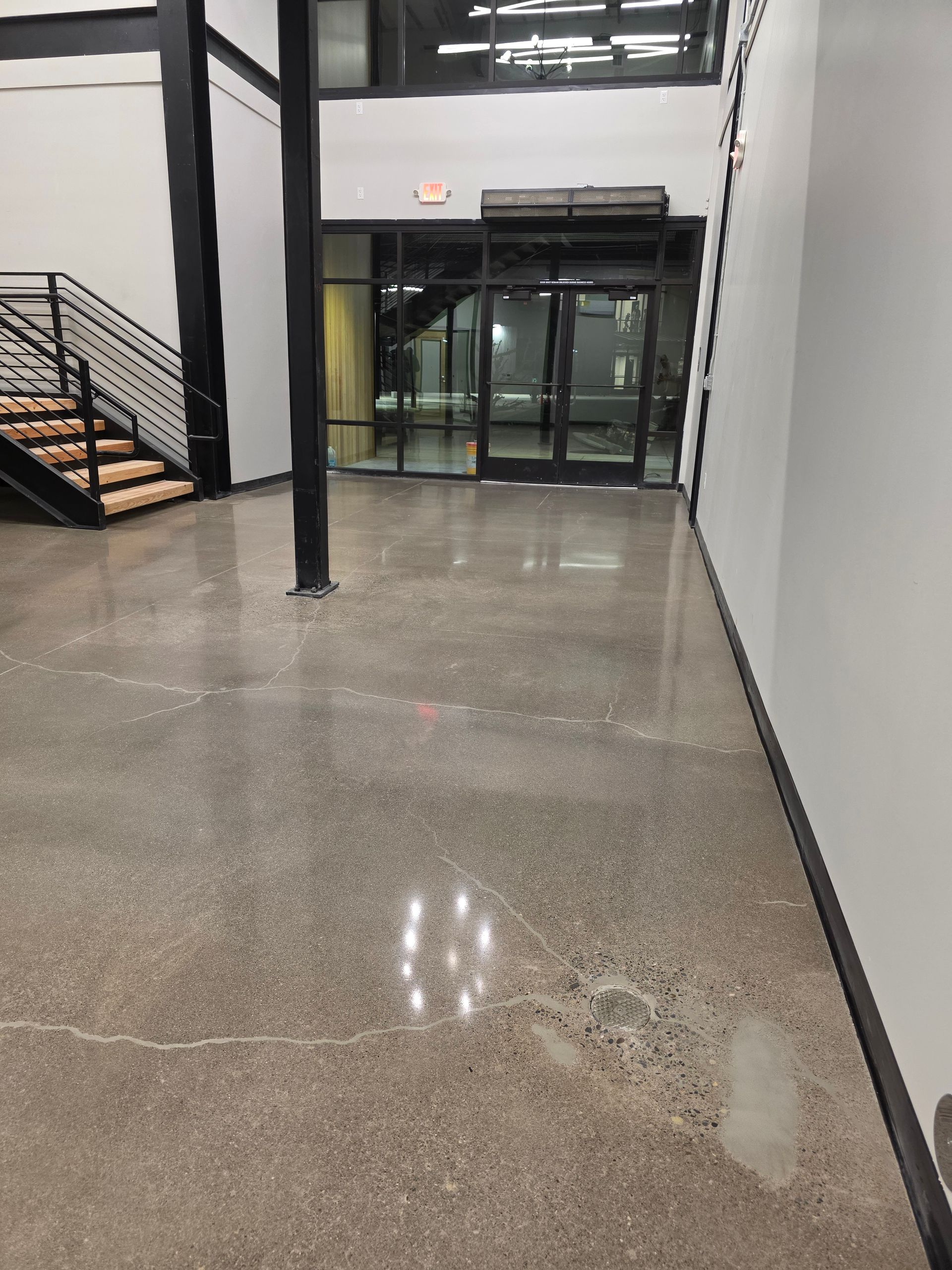 Open truck interior filled with stacked tires, tire changing machine, tools, and a ladder, outdoors.