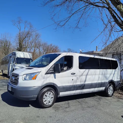 A crowd of people at a concert with their hands in the air.