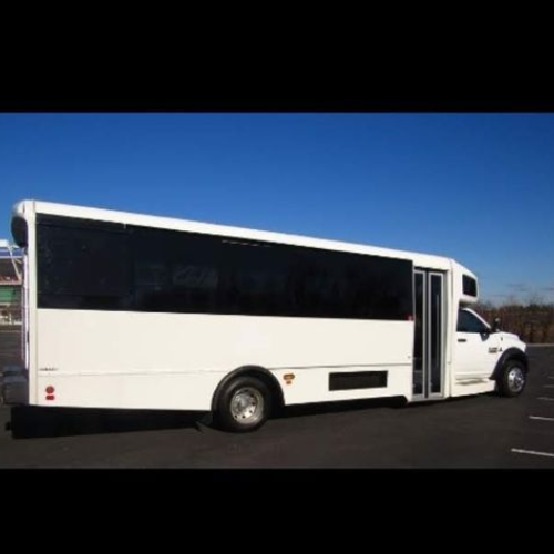 A black limousine is driving down a highway.