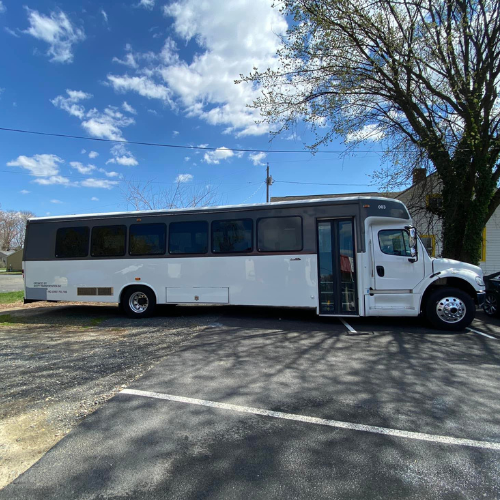 A group of women standing in front of a white limousine