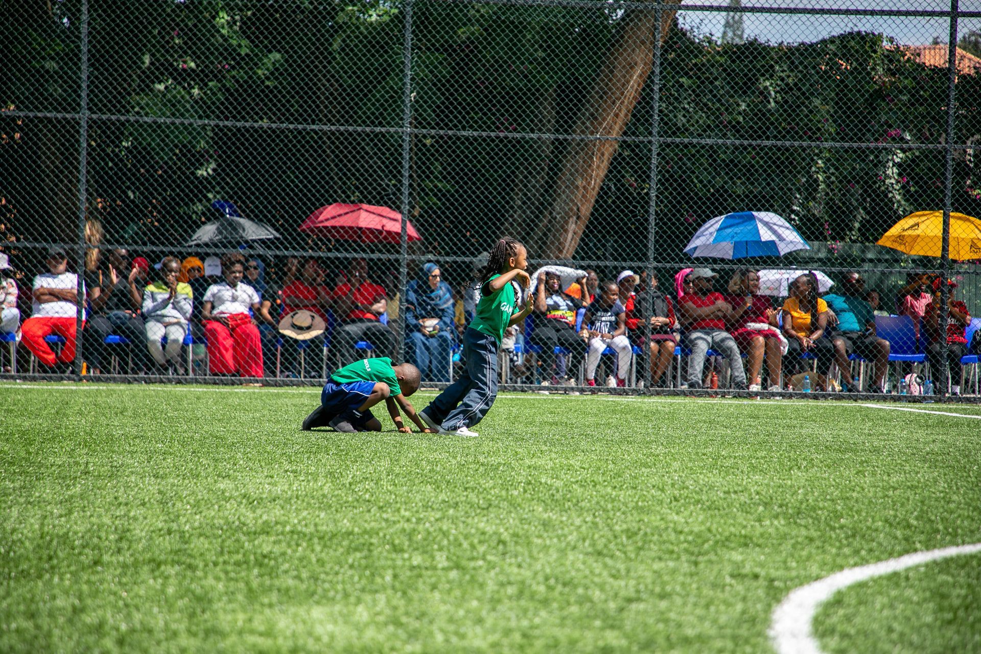 A group of children are playing on a soccer field.