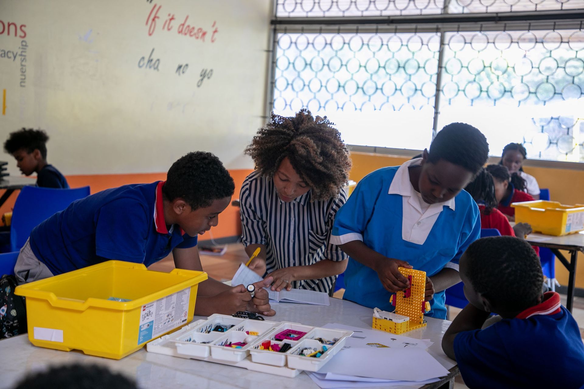 A group of children are working on a project in a classroom.