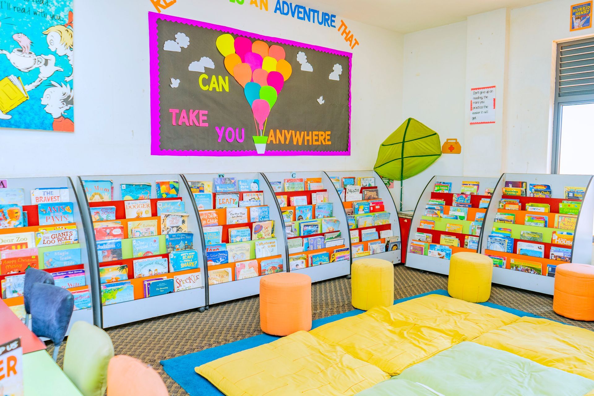 A table with paintings on it in a classroom