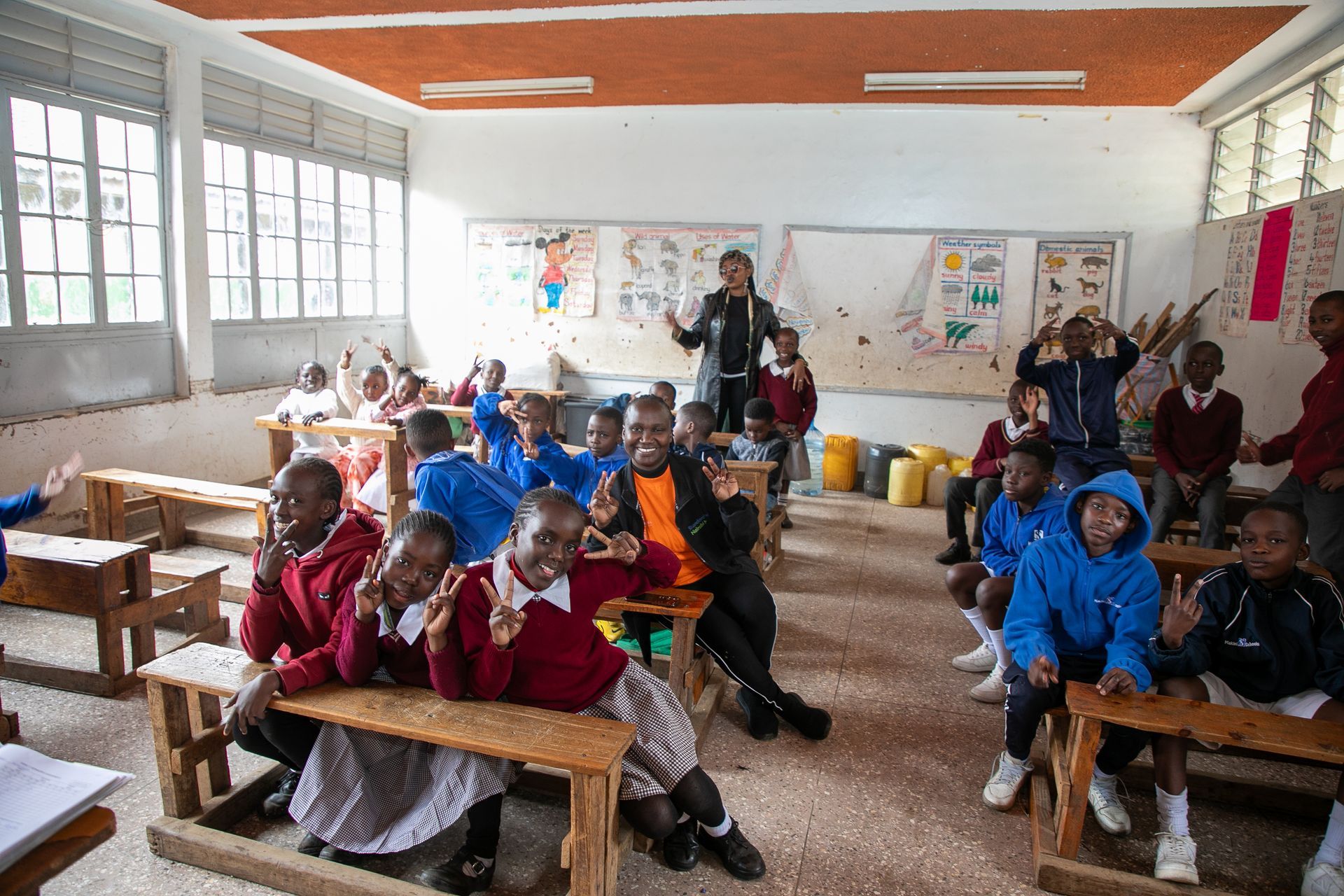 A group of children are sitting at desks in a classroom.