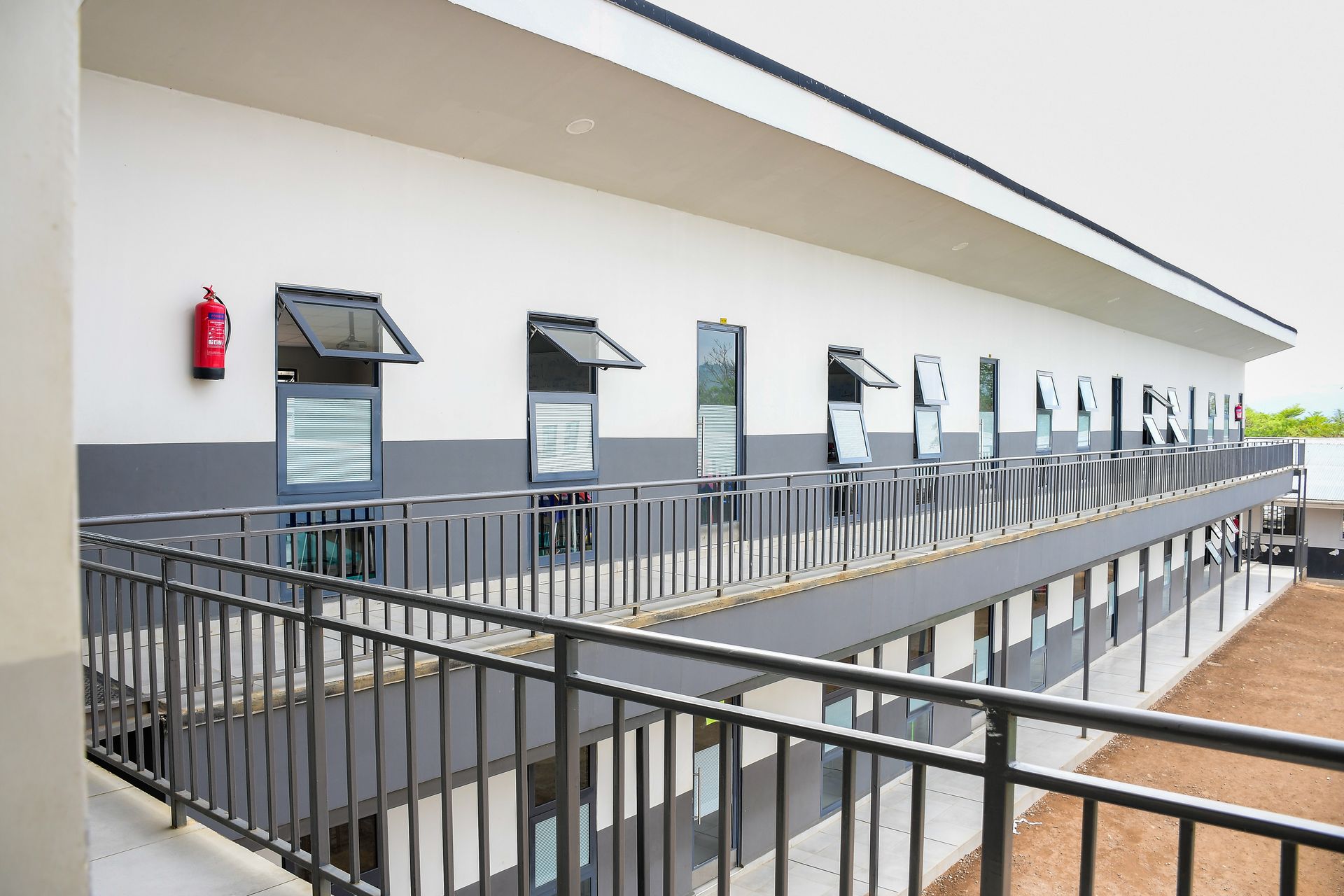 A boy and a girl are standing next to each other in a garden.
