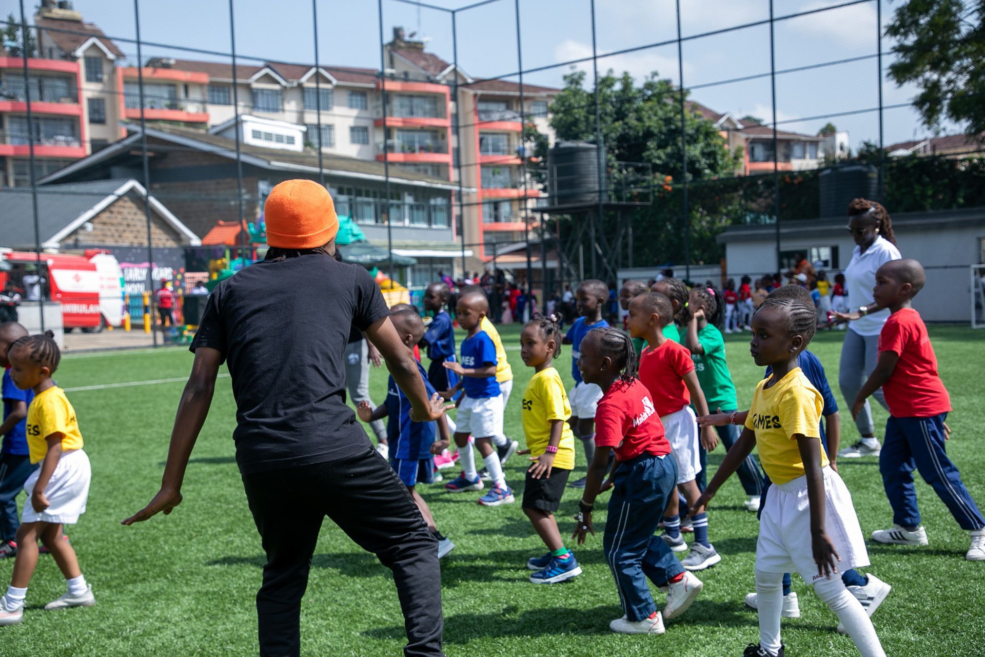 A group of children are playing soccer on a field.