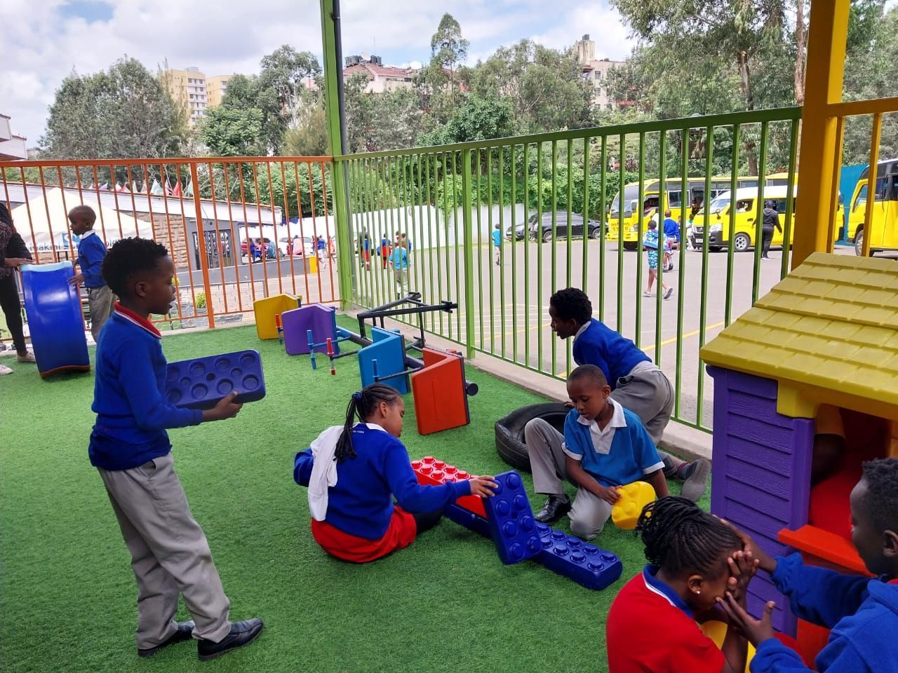 A group of children are playing with toys in a playground.