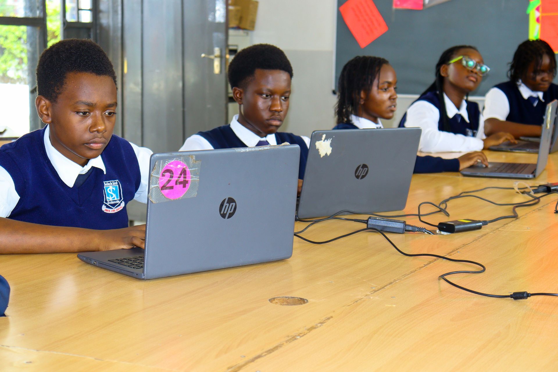 A group of people are reading books in a library.