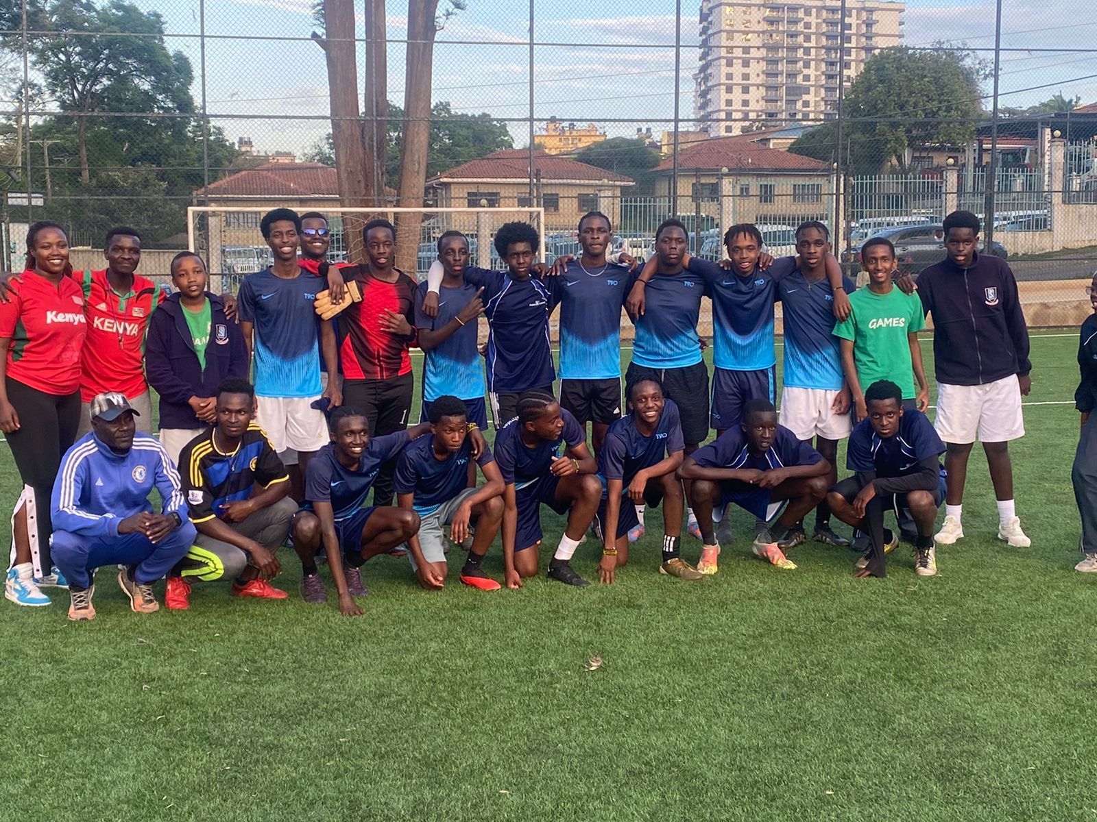 A group of young men are posing for a picture on a soccer field.