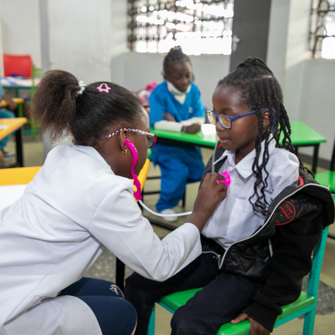 A woman is using a stethoscope to listen to a child 's heartbeat