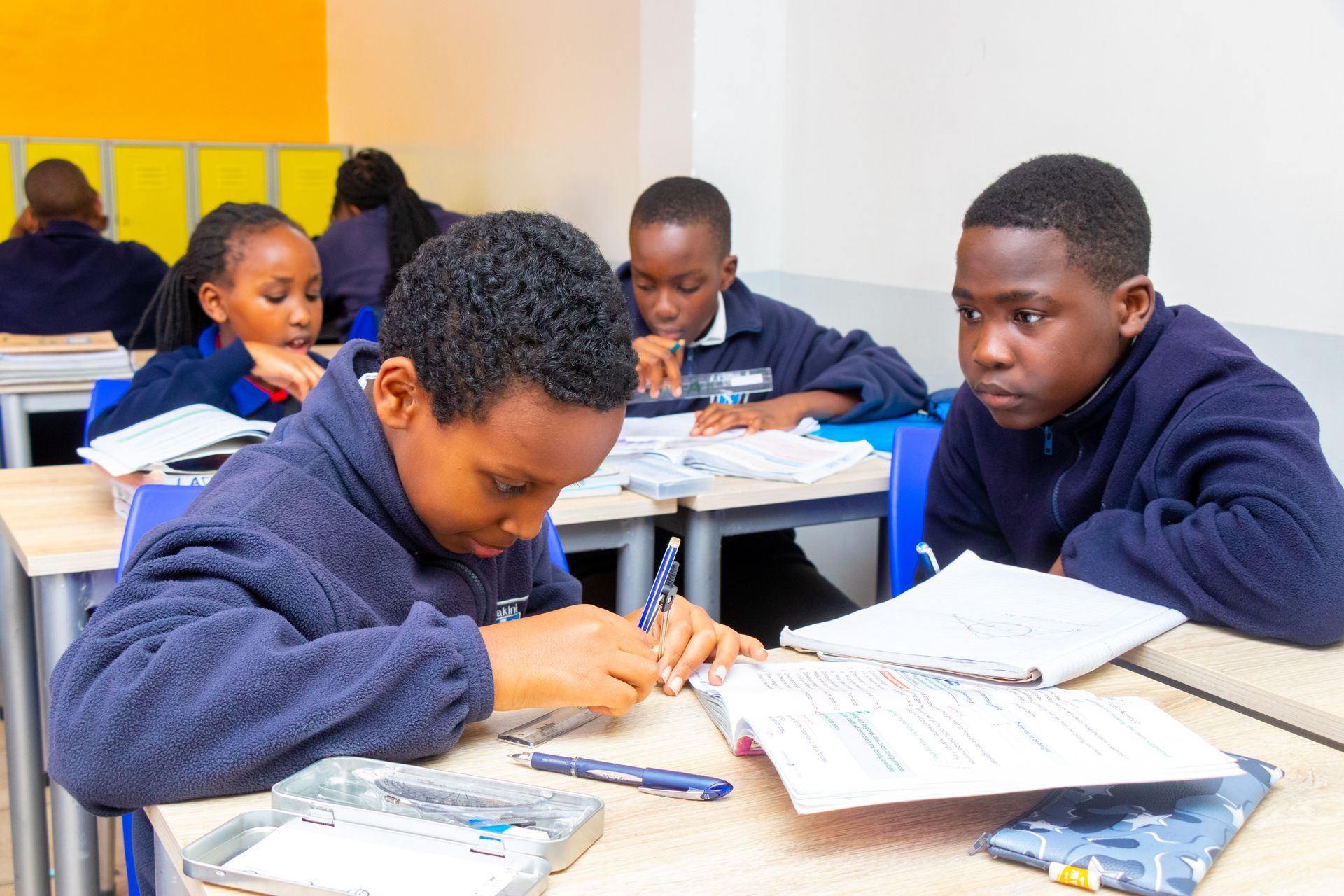 A group of children are sitting at desks in a classroom.