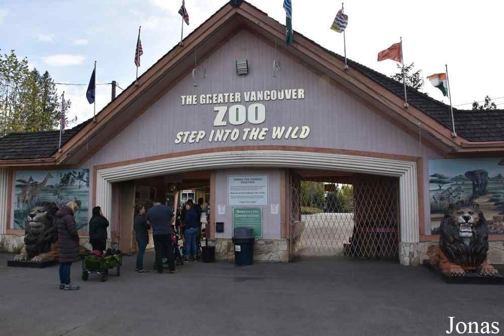Entrance to The Greater Vancouver Zoo with people near the gate and animal statues on both sides