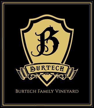 Black and gold logo for Burtech Family Vineyard: shield with ornate "B" and banner reading "BURTECH".