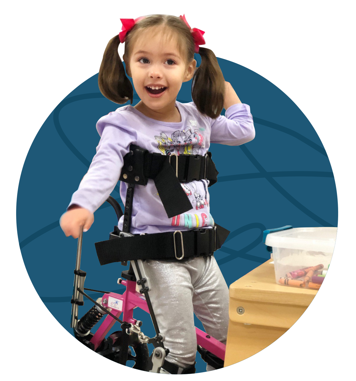 Smiling girl with pigtails using a pink walker and harness.